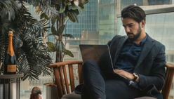 man sitting beside side table
